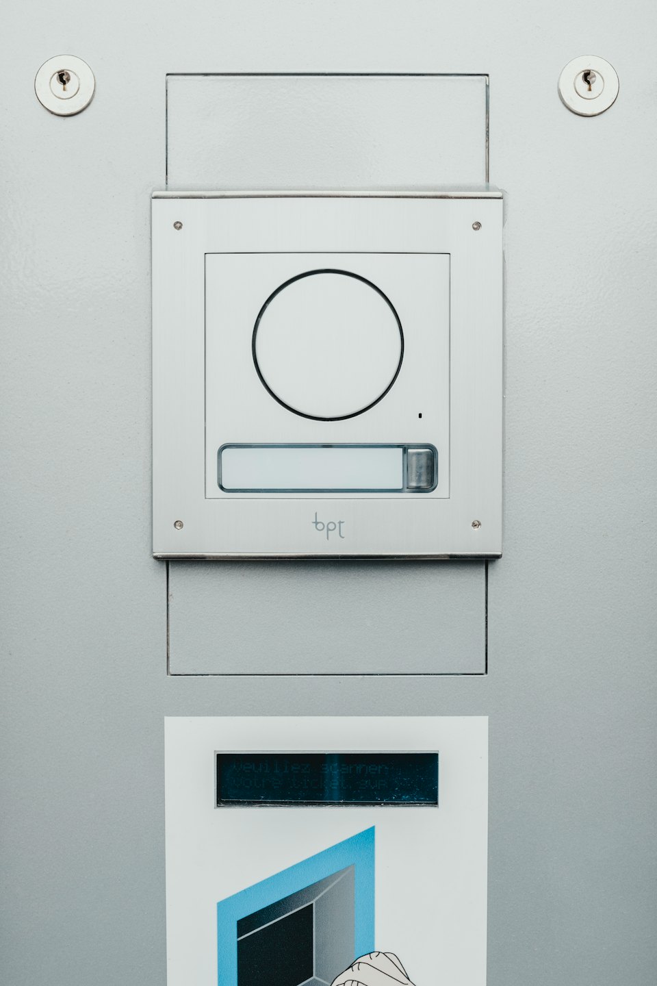 Modern access control panel with speaker and ticket slot.